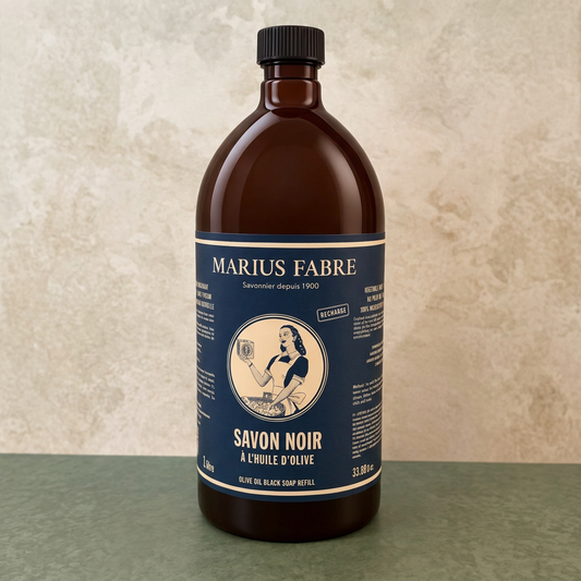 Marius Fabre olive oil black soap bottle on a beige and green background